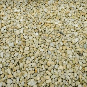 A large collection of gold quartz stones labeled 'GOLD QUARTZ 20MM' spread evenly on the ground.