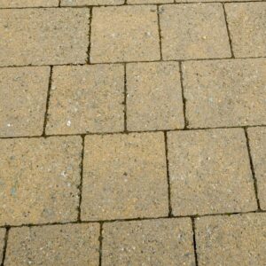 Paved pathway with a sample label showing "LISMORE CURRAGH GOLD" next to a section of loose small golden stones.