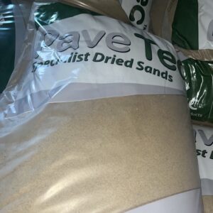 Several packaged bags of specialist dried sands with the brand name "Pave Tec" visible in green and white lettering.