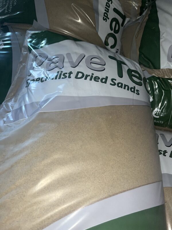 Several packaged bags of specialist dried sands with the brand name "Pave Tec" visible in green and white lettering.